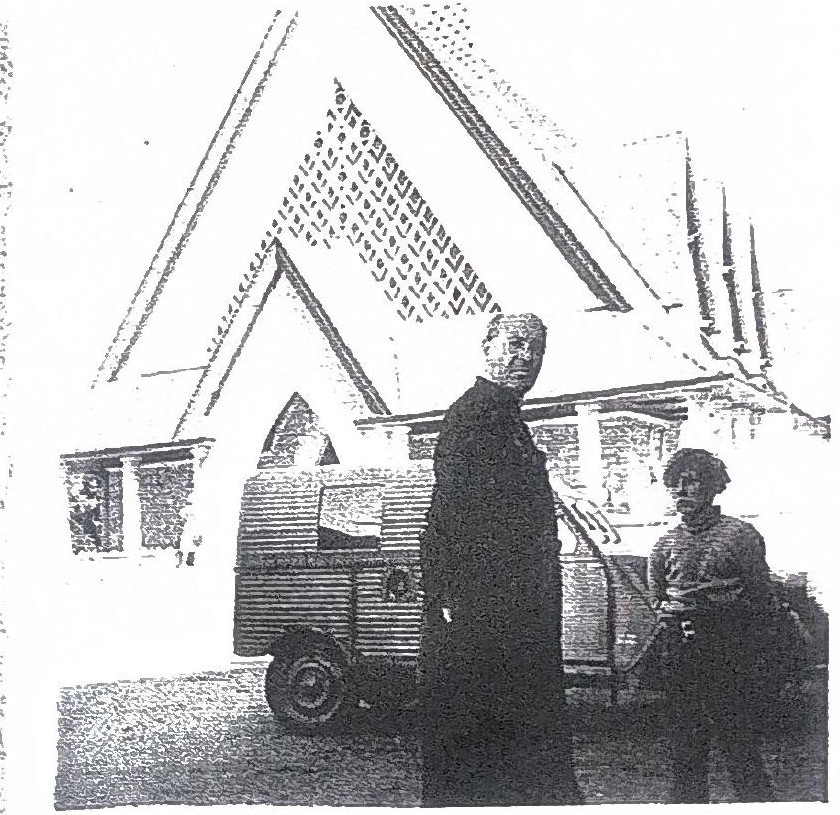 Page 59 de l'album : le Père Cesné photographié par le cardinal Martin devant l'église d'Assy, Notre-Dame-de-Toute-Grâce, à côté de la 2 CV « La Rosalie ».